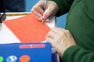 volunteer-writting-on-red-voucher